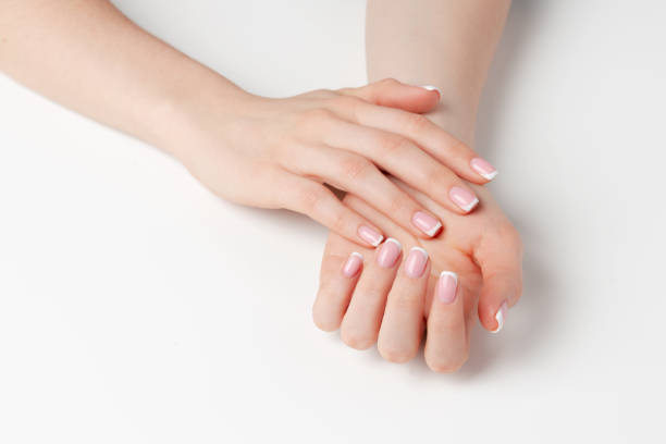istock Well-groomed female hands with manicure on white background 1289358686