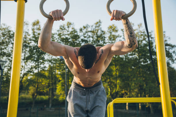 istock Athletic young man preparing and checking gymnastic rings 1289359382