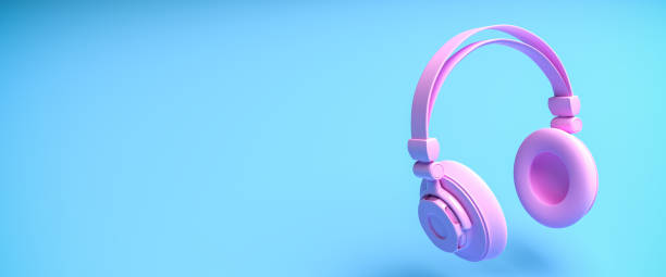 istock Music concept: A pink headphone against a blue background with shadow. Web banner size with copy space 1289360209