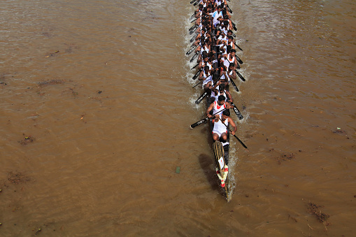 Kottayam, Kerala, India - September 30,2012 : Unidentified oarsmen rowing their snake boats to participate in the boat race held as part of the Onam celebrations in Kottayam, Kerala, India