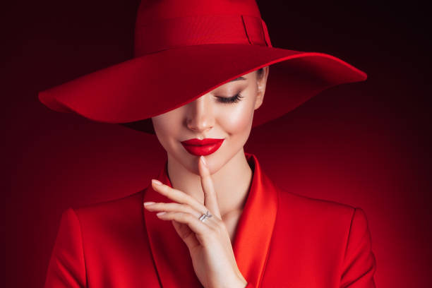 istock Beautiful girl with make-up wearing red jacket and hat 1289361700
