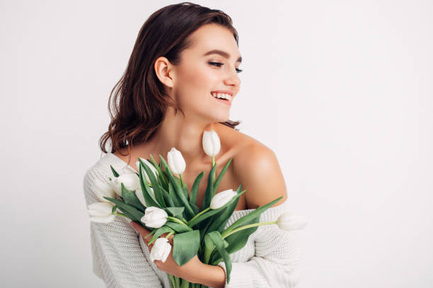 Happy woman with bouquet of tulips Happy woman with bouquet of tulips white tulips stock pictures, royalty-free photos & images