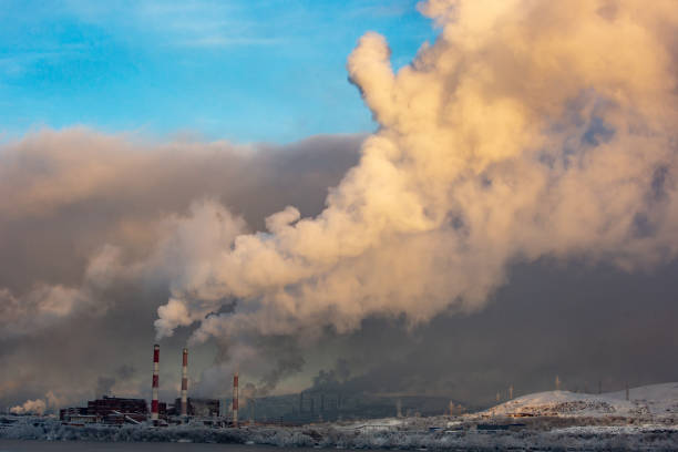 istock smoking chimney against the sky 1289363919