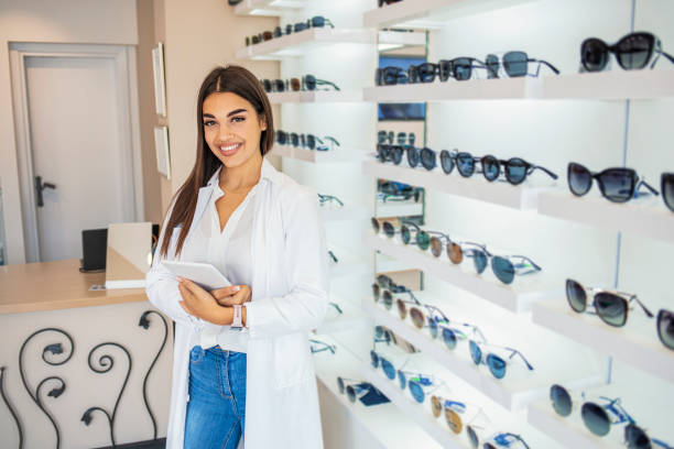 istock Posing optometrist woman in eyeglasses store smiling looking at camera. 1289364335