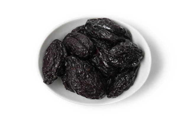 istock Prune, dehydrated plums isolated on white 1289364393