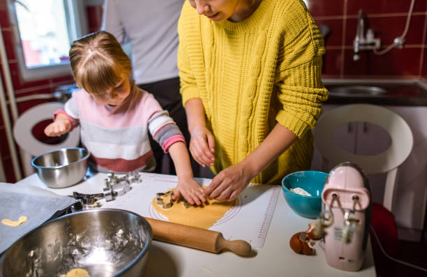 istock Mother and daughter makes cookies together 1289365492