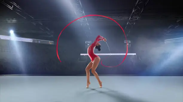 Photo of Rhythmic gymnast in professional arena.