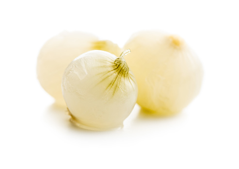Pickled mini baby onions isolated on white background.