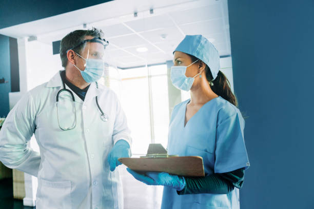 istock Healthcare workers discussing over record 1289366992