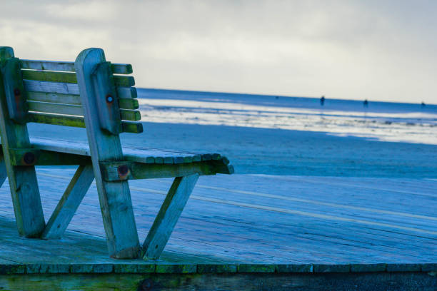 istock Wooden Bench on Beach of St. Peter-Ording Germany 1289367100