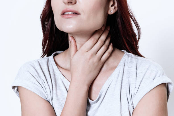 istock A woman has a sore throat. 1289369529