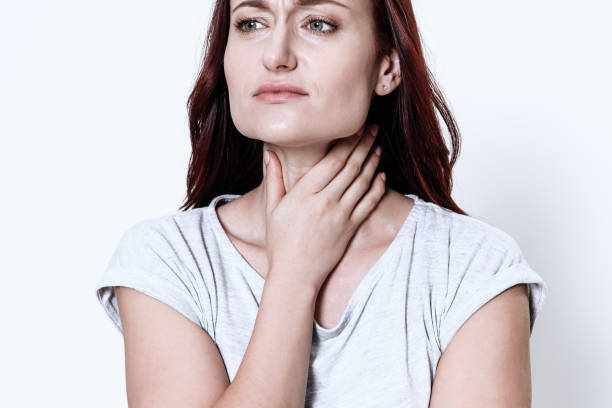 istock A woman has a sore throat. 1289369577
