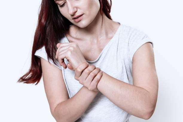 istock A woman has a pain in her arm. 1289369631