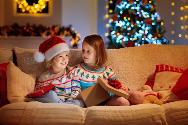 istock Child at Christmas tree. Kids at fireplace on Xmas 1289371244
