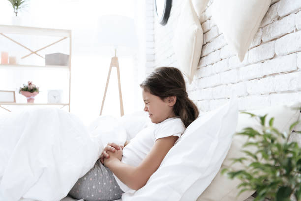 istock The girl has a stomach ache. 1289371406