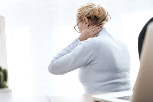 istock A woman has a sore neck. 1289371772