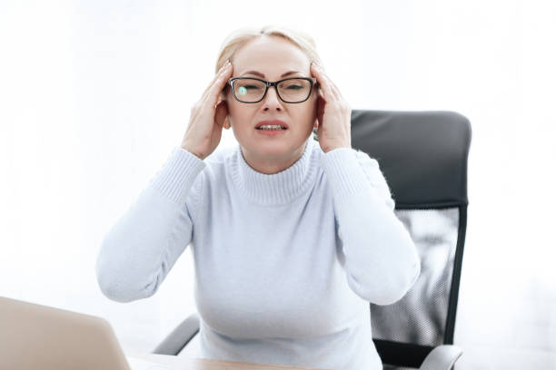 istock A brunette woman has a headache. 1289371955