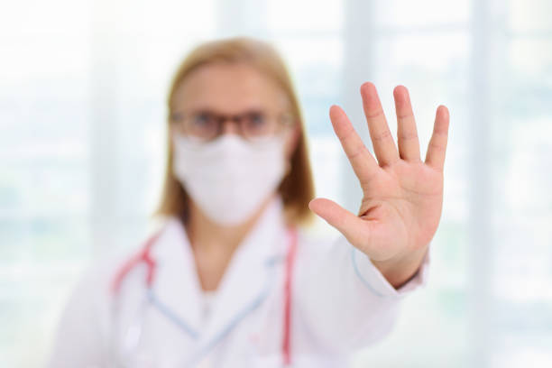 istock Doctor or nurse with stethoscope and face mask. 1289372792