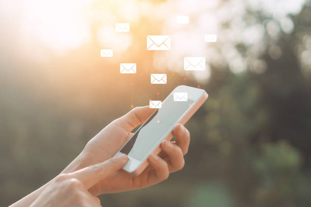 istock Copy space hand using smart phone with email icon on street abstract background. Travel adventure lifestyle and business economic concept. 1289372976