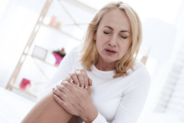 istock A woman has a knee pain, she is doing a massage. 1289373195