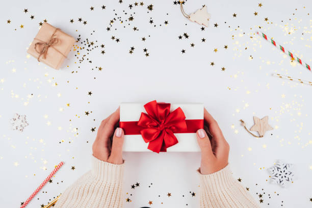 istock Gift box in your hands on a festive background 1289374465