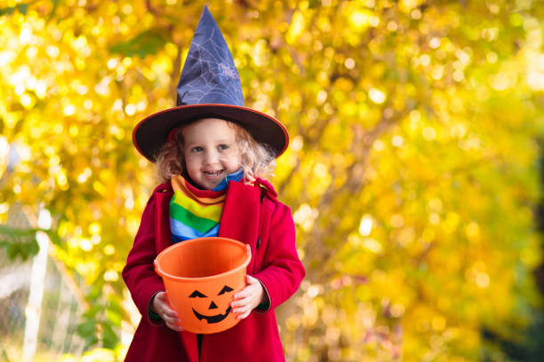 istock Kids trick or treat on Halloween night. 1289374734
