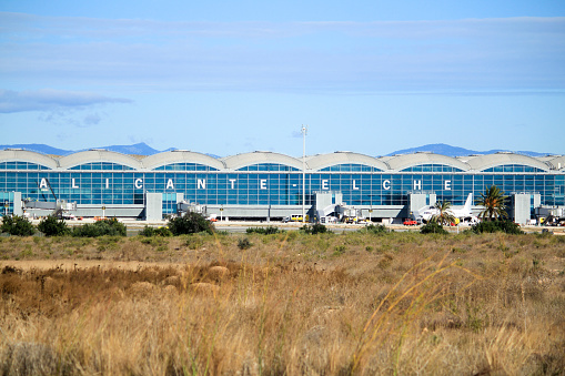 El Altet, Elche, Alicante, Spain- November 30, 2020: Panoramic view of the airport of Alicante in a sunny day of Winter. Planes of different companies landing and taking off