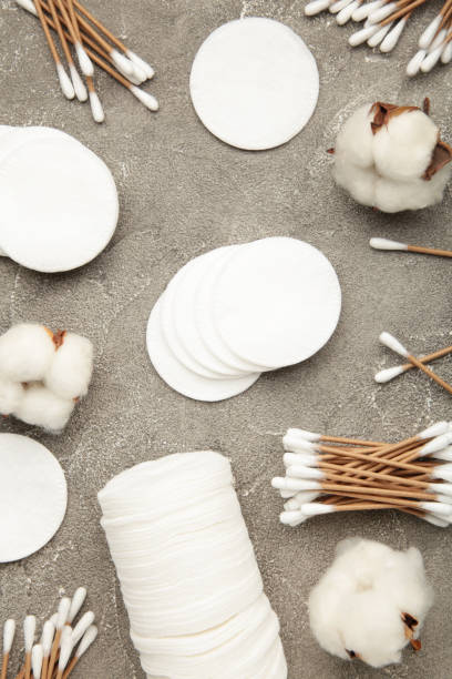 istock Cotton swabs and sticks with flowers on grey background 1289375927