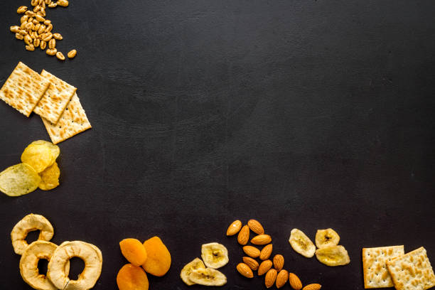 istock Healthy snacks for students - nuts and fruits mix top view 1289377299