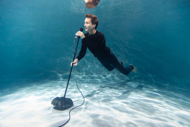 Singer Man with Microphone Underwater. Copy Space. Art