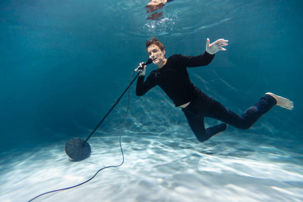 istock Singer Man with Microphone Underwater. Copy Space. Art 1289377393