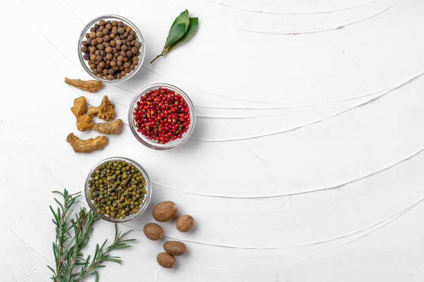Top view of different spices on white textured background