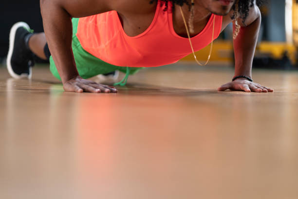 istock Athlete doing push up in the gym while not wearing a shirt and is stressed from exercise 1289380216