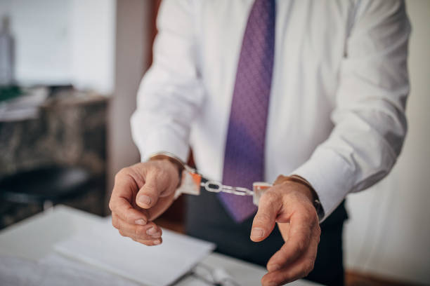 Businessman arrested, handcuffed