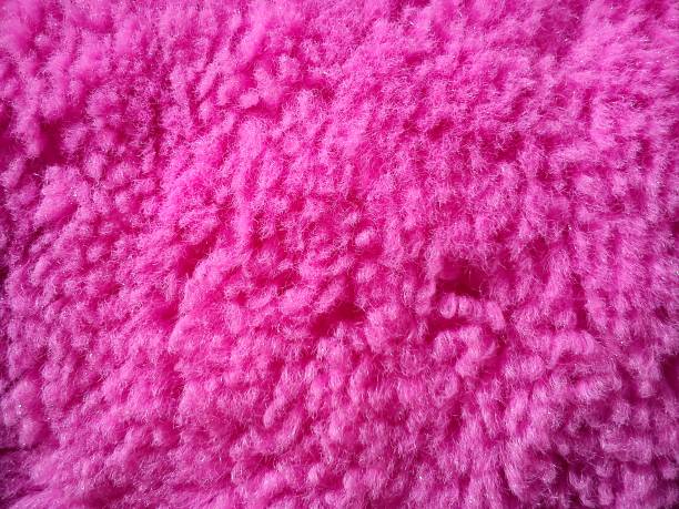 istock Soft pink plush material for baby toy, wool with spools. 1289383472
