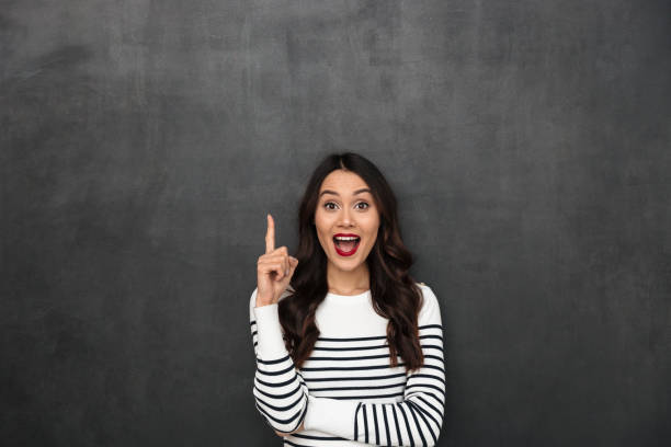 istock Surprised happy brunette woman in sweater having idea 1289385020