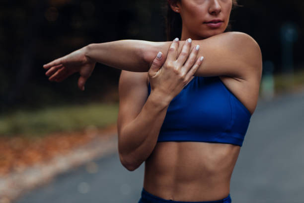istock Sporty female stretching muscles before workout 1289385438