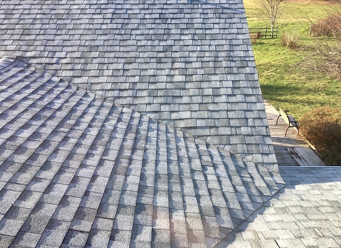 Newly installed asphalt shingles are light gray in color for higher sun reflectance. As climate changes, lighter colors are helpful for keeping the house interior cooler in hot months.  Light colored shingles also stay in better condition by absorbing less heat than dark colored ones.