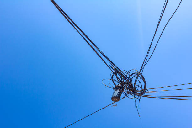 istock Bunch of tangled cables, blue clear sky is above 1289388367