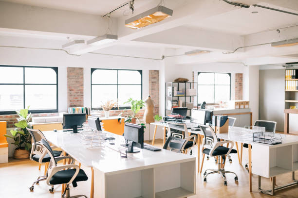 Interior of open office space Interior of modern open office space with desk and chairs. small office stock pictures, royalty-free photos & images