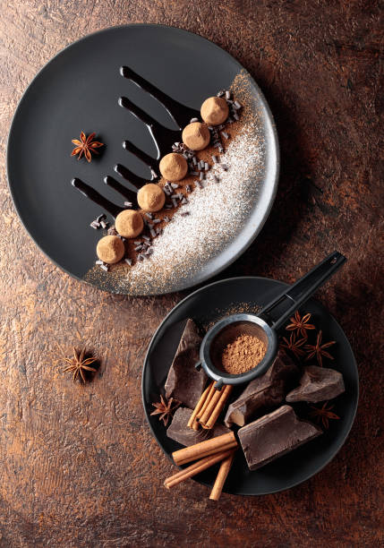 istock Chocolate truffles on a black plate with chocolate sauce. 1289396672