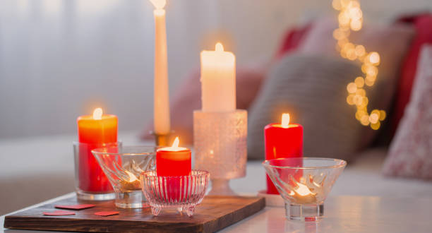 istock Burning candles on white table in interior. Valentines day concept 1289401866