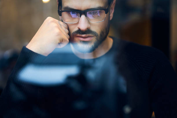 istock Concentrated thinking bearded guy in eyeglasses 1289404260