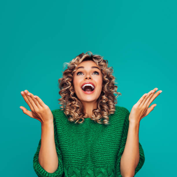 istock Beautiful girl on colored background showing up with her hands 1289404298