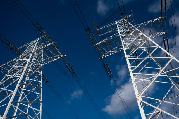 istock Power line tower on a background of blue sky with clouds 1289404345