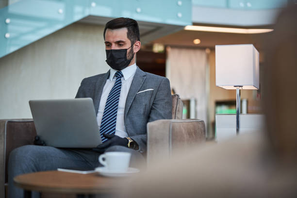 istock Calm businessman using modern gadget in the airport 1289407962