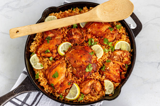 istock One Pan Spanish Chicken and Rice in a Skillet with Serving Spoon 1289408677