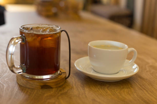 istock ice coffee with hot tea on wood table. 1289409852