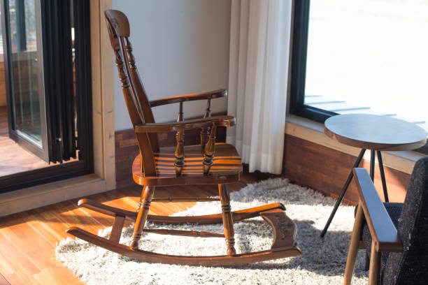 istock Rocking chair in front of the window. 1289409867