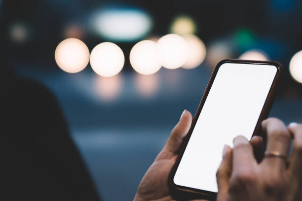 istock Crop person using smartphone on street 1289410301